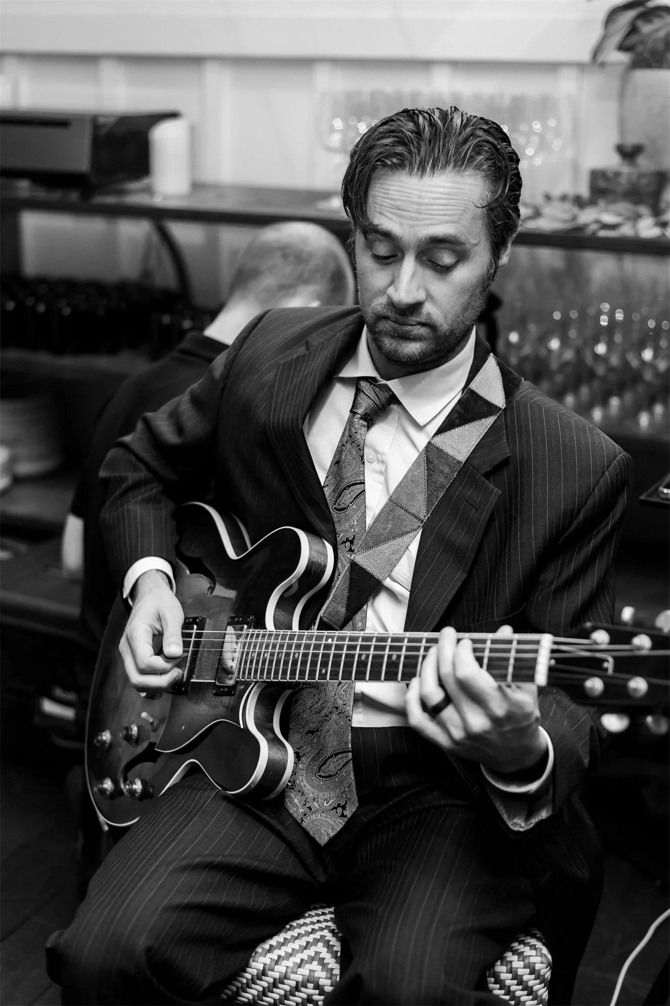 Ford Nelson playing guitar in a suit at an event
